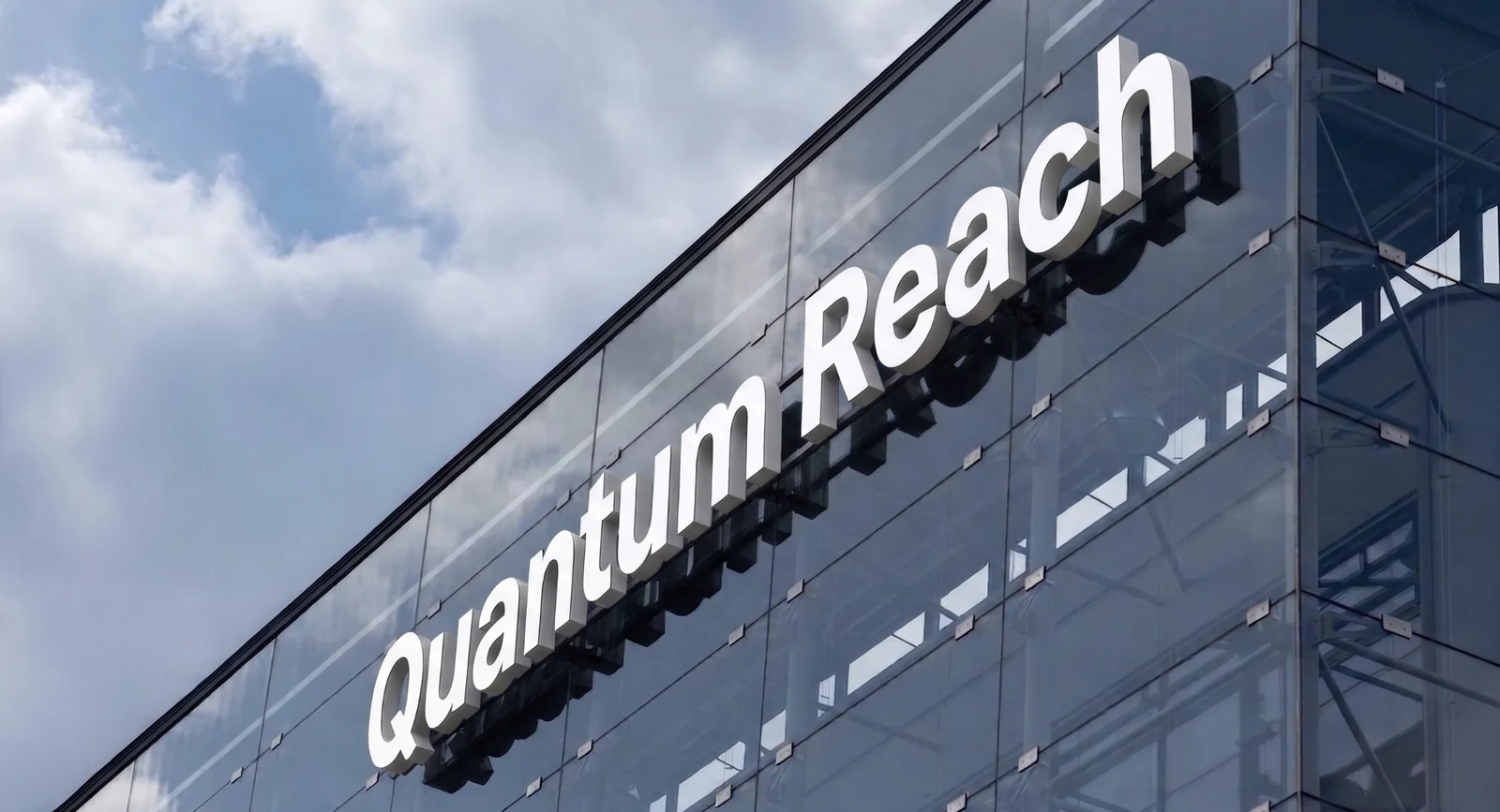 Quantum Reach signage on a glass building